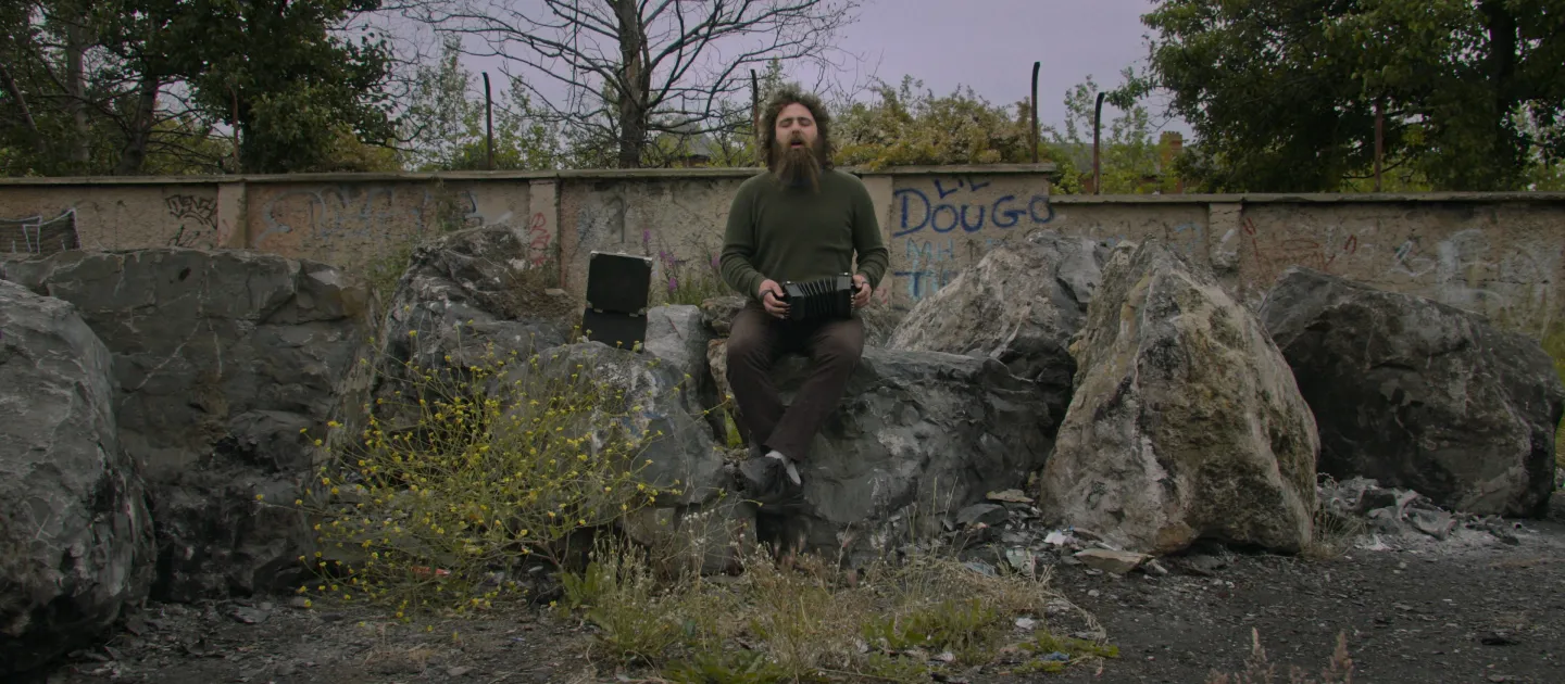 CELTIC UTOPIA main image, man sitting on rock 