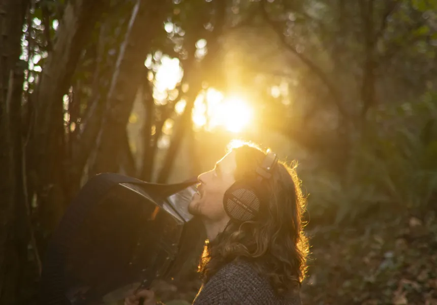 BIRDSONG still featuring Sean Ronayne in profile against a backdrop of woods and sunshine