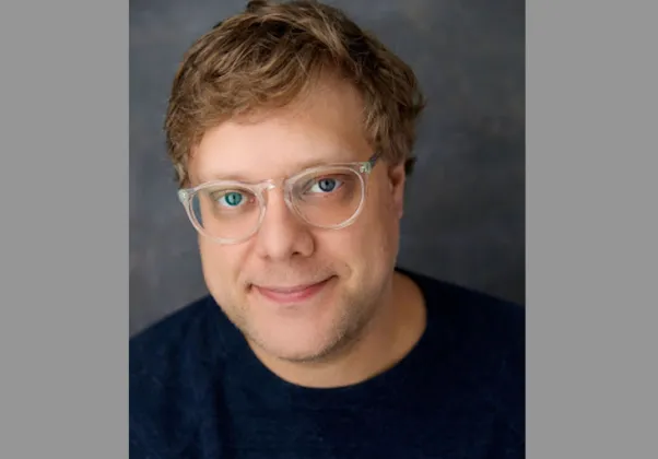 portrait of Andrew Dolan against dark gray background