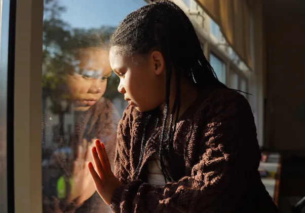 KIKI image, little girl looking out window